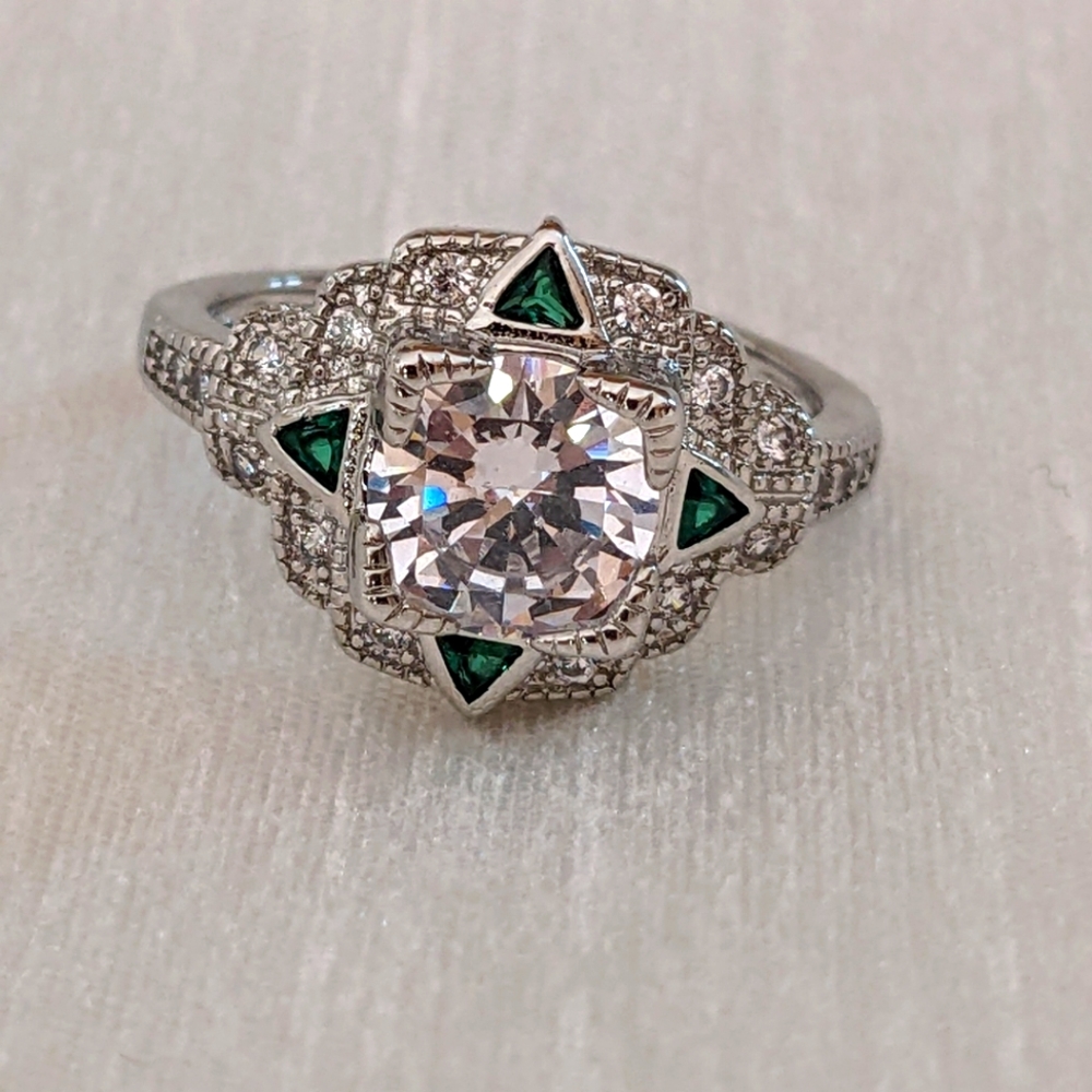Vintage-inspired zircon ring with green accents.